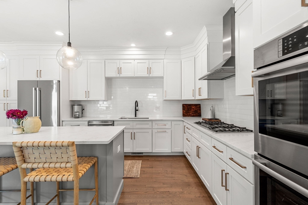 32 Cutter Lane, Unit 32 Amesbury, MA 01913 - Photo 6 of 37 a kitchen with stainless steel appliances kitchen island granite countertop a sink stove and cabinets