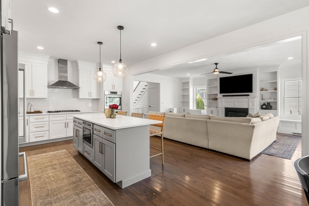 32 Cutter Lane, Unit 32 Amesbury, MA 01913 - Photo 7 of 37 a kitchen that has a lot of white cabinets and wooden floor