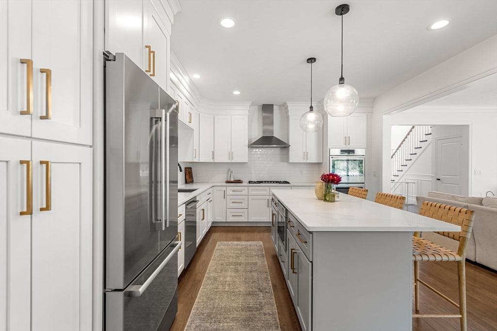 32 Cutter Lane, Unit 32 Amesbury, MA 01913 - Photo 8 of 37 a kitchen with a refrigerator a sink and cabinets