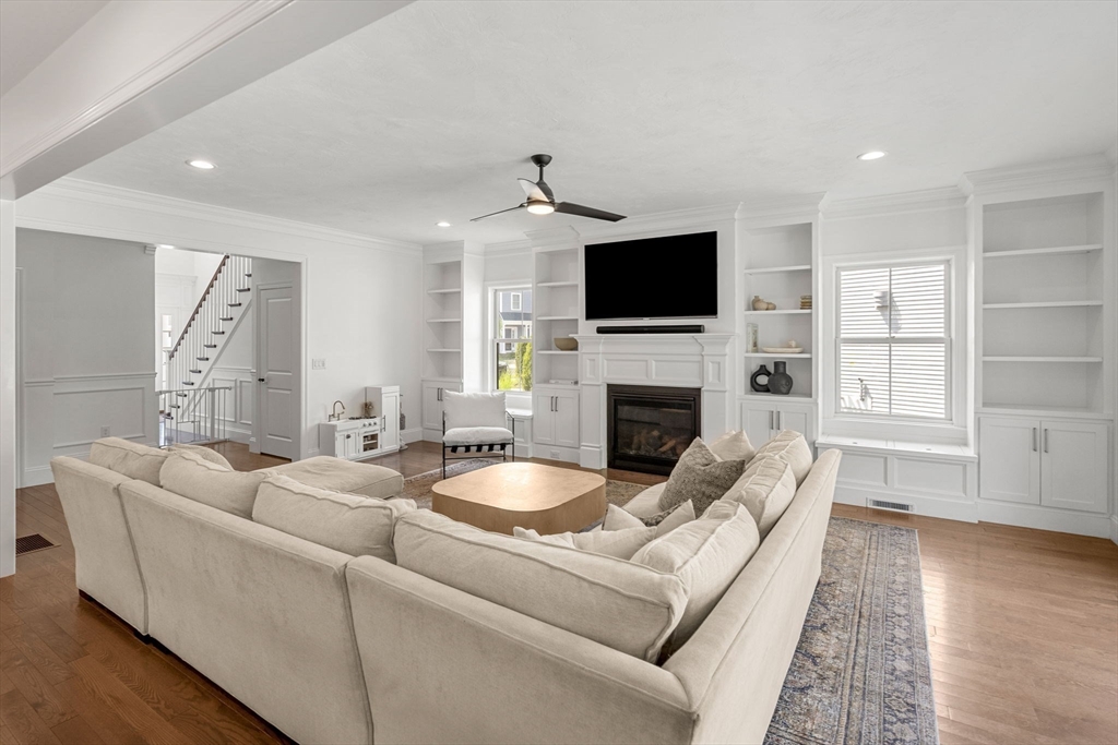 32 Cutter Lane, Unit 32 Amesbury, MA 01913 - Photo 9 of 37 a living room with furniture a fireplace and a flat screen tv