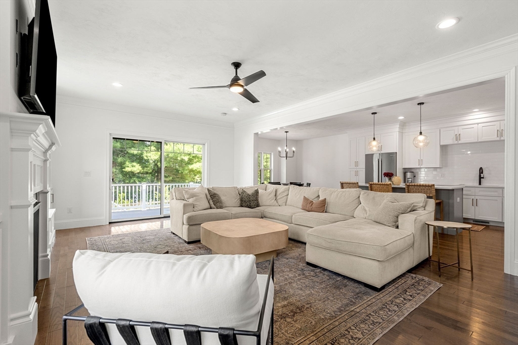 32 Cutter Lane, Unit 32 Amesbury, MA 01913 - Photo 10 of 37 a living room with furniture a flat screen tv and a large window