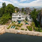 an aerial view of a house with a yard basket ball court and outdoor seating