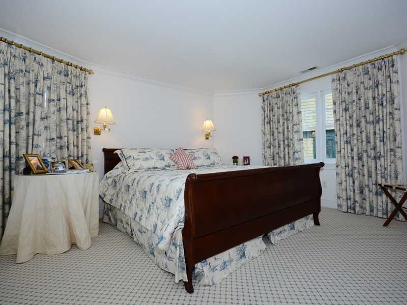 16 Rocky Point Road Rowayton, CT 06853 - Photo 17 of 25 a bed room with a bed window and wall painting