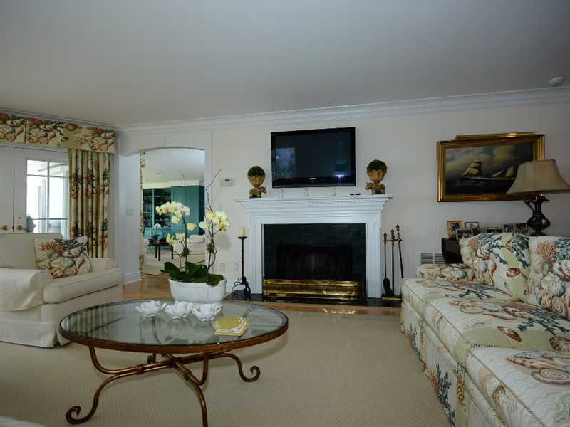 16 Rocky Point Road Rowayton, CT 06853 - Photo 8 of 25 a living room with furniture a flat screen tv and a fireplace