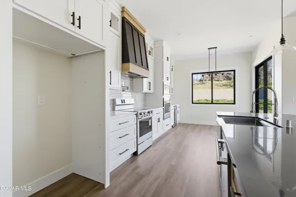 a kitchen with stainless steel appliances a sink and cabinets