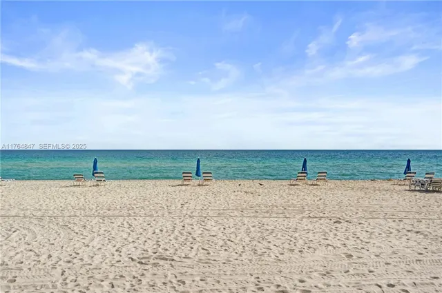 a view of a dirt road with a building in the background