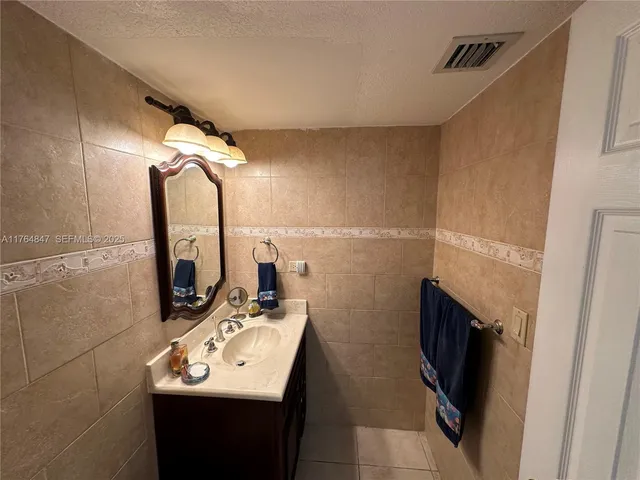 a bathroom with a sink a toilet a mirror and vanity
