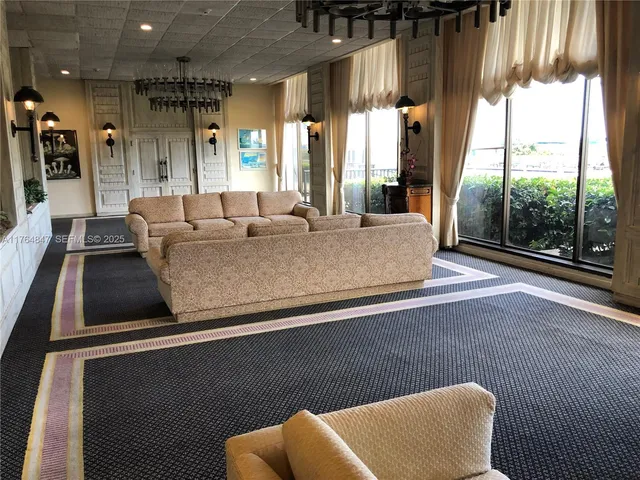 a living room with furniture and a floor to ceiling window