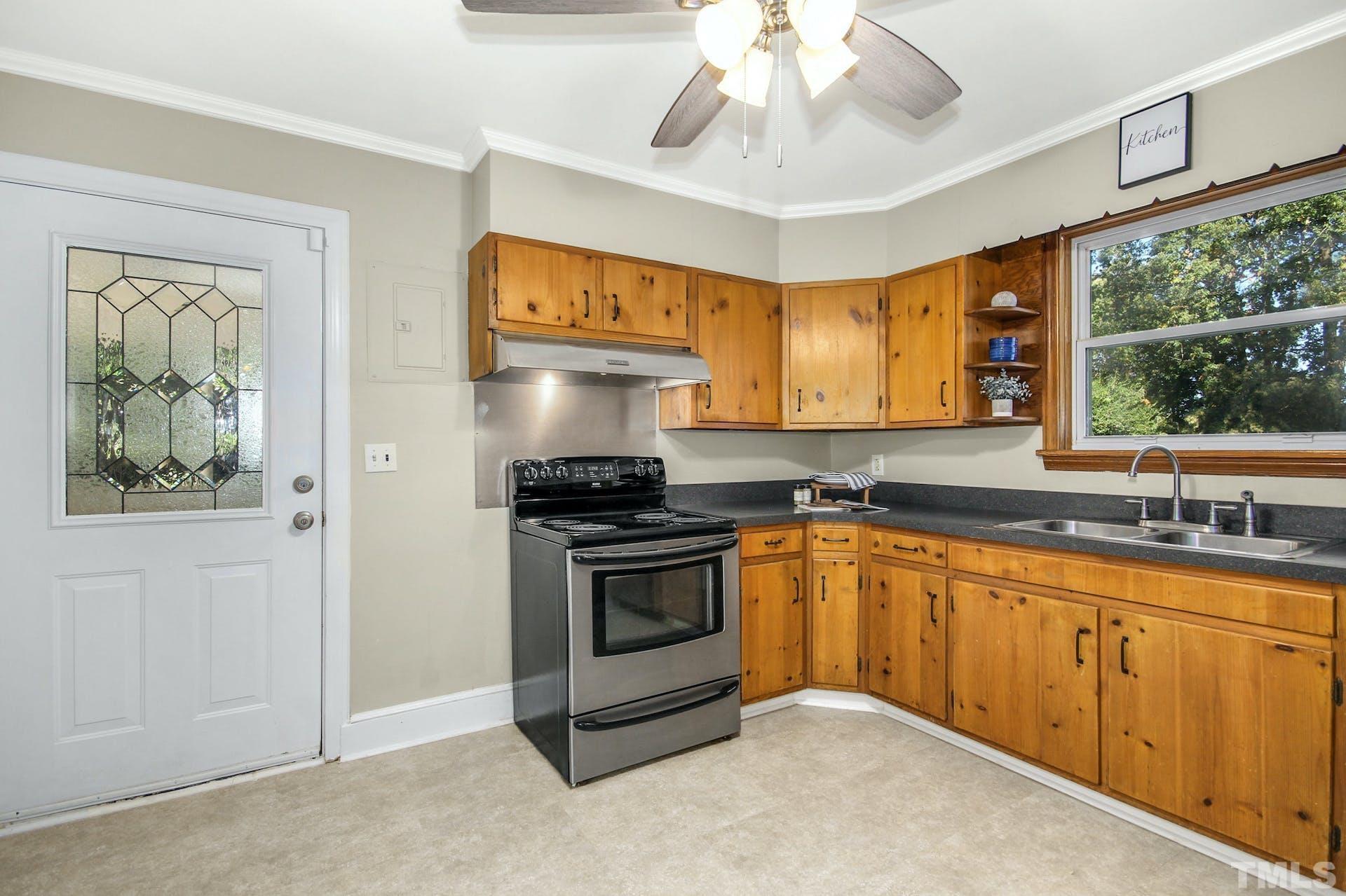 2805 Haven Road Raleigh, NC 27610 - Photo 18 of 29 a kitchen with stainless steel appliances granite countertop a stove a sink and a microwave