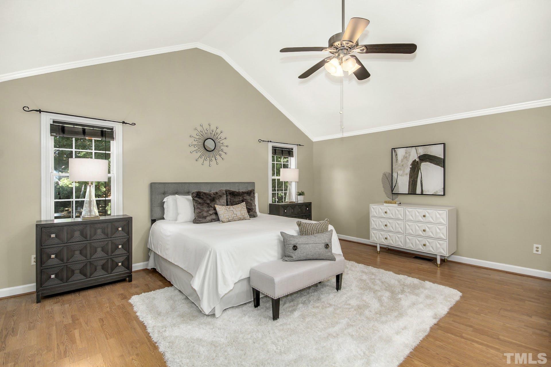 2805 Haven Road Raleigh, NC 27610 - Photo 9 of 29 a bedroom with a bed and a chandelier