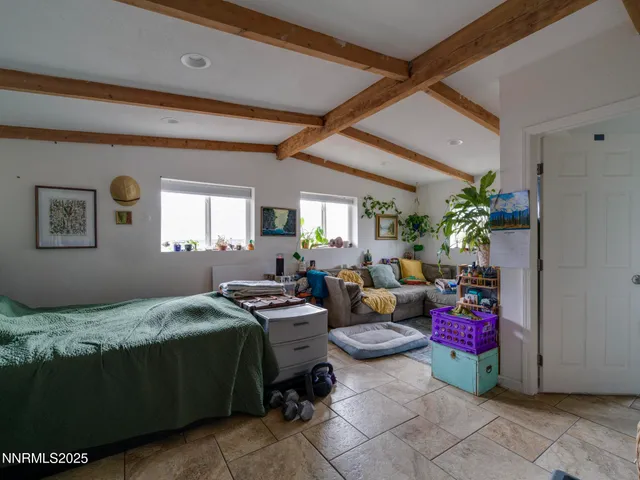 a bedroom with bed furniture and window