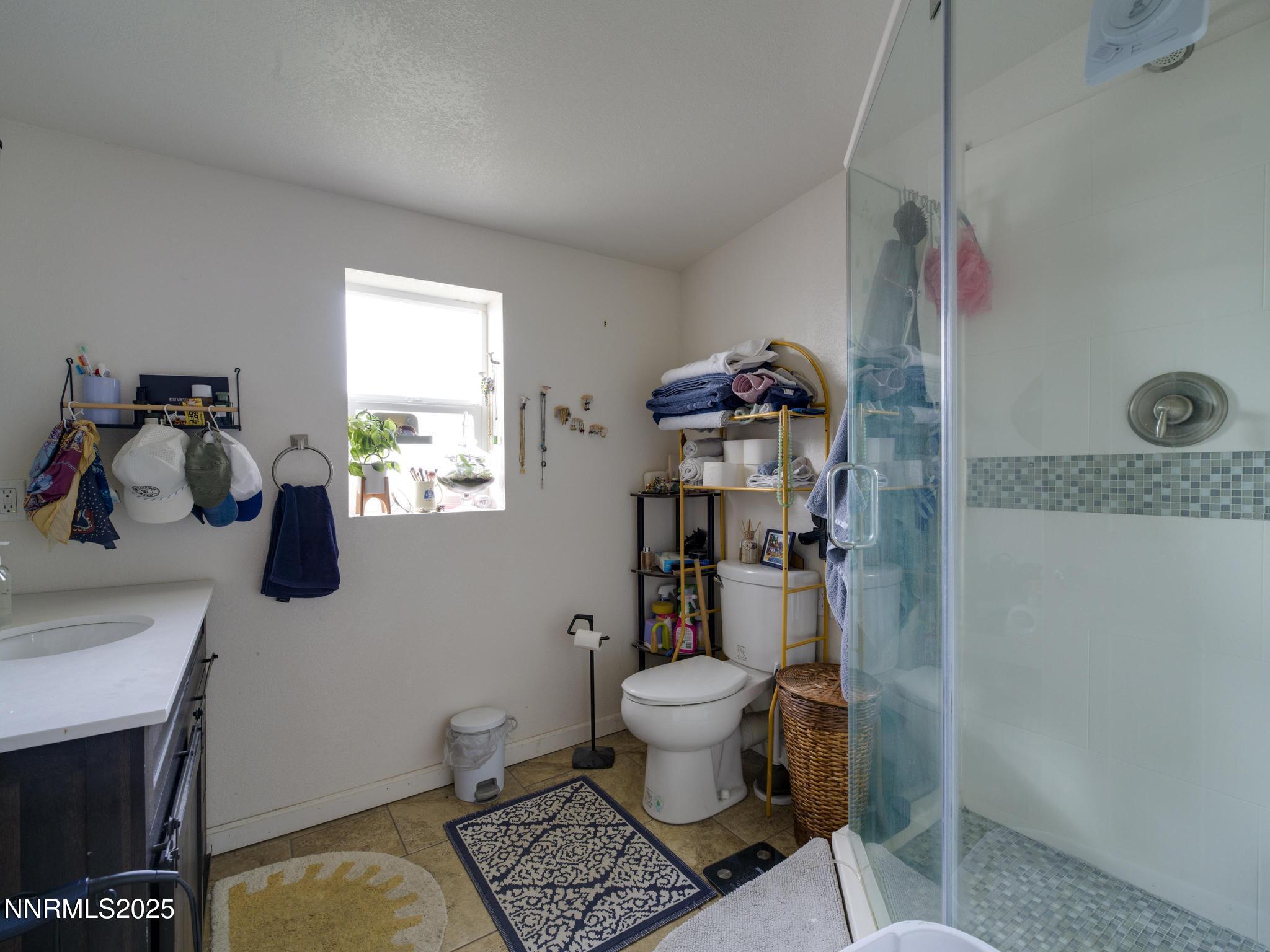 1840 Windsor Way Reno, NV 89503 - Photo 15 of 21 a bathroom with a granite countertop toilet sink and mirror