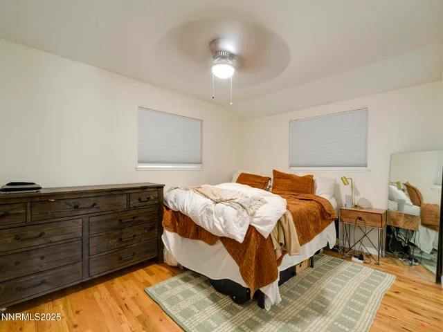a bedroom with a bed and lamp with dresser