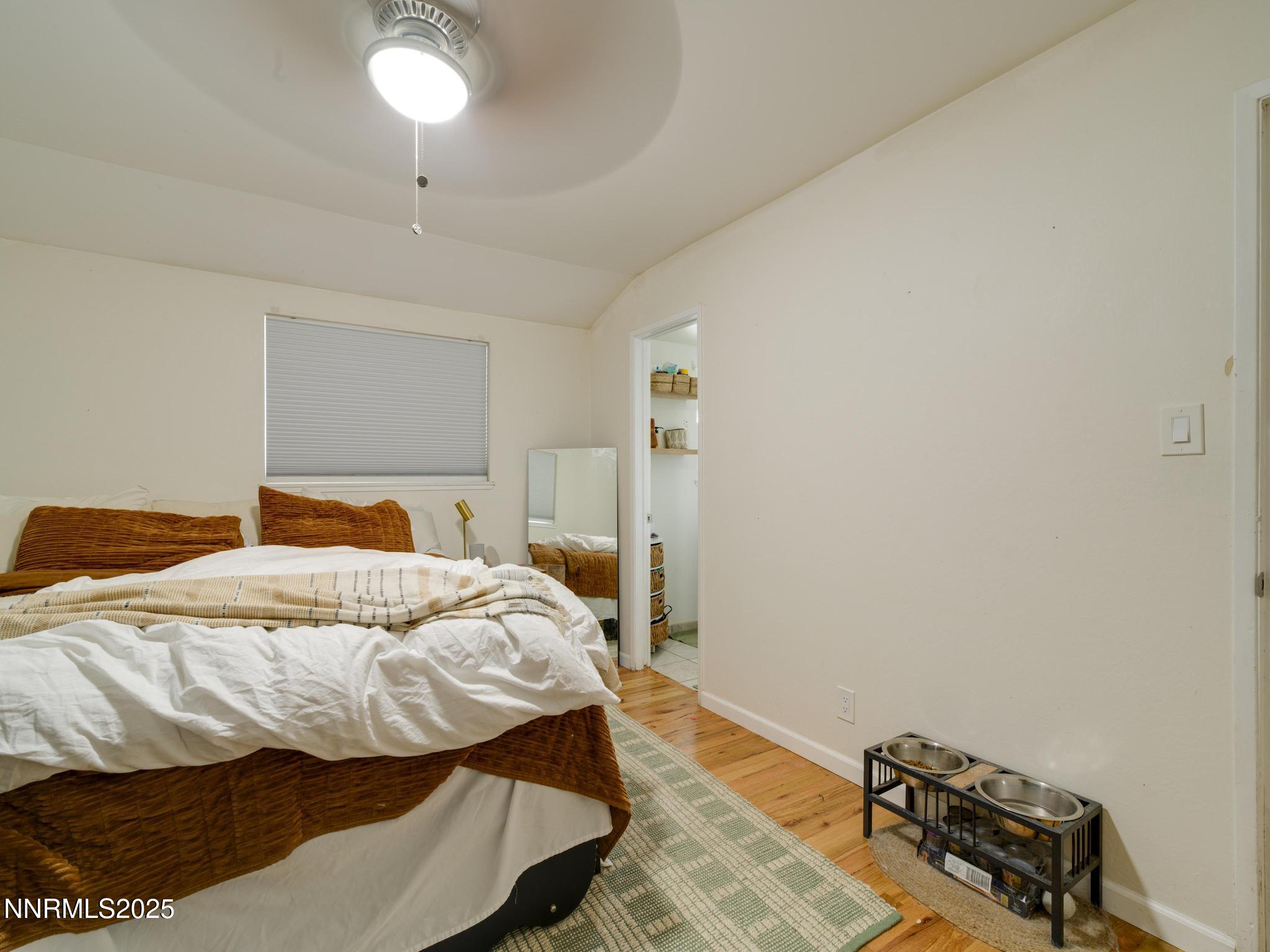 1840 Windsor Way Reno, NV 89503 - Photo 17 of 21 a bedroom with a bed and a chandelier