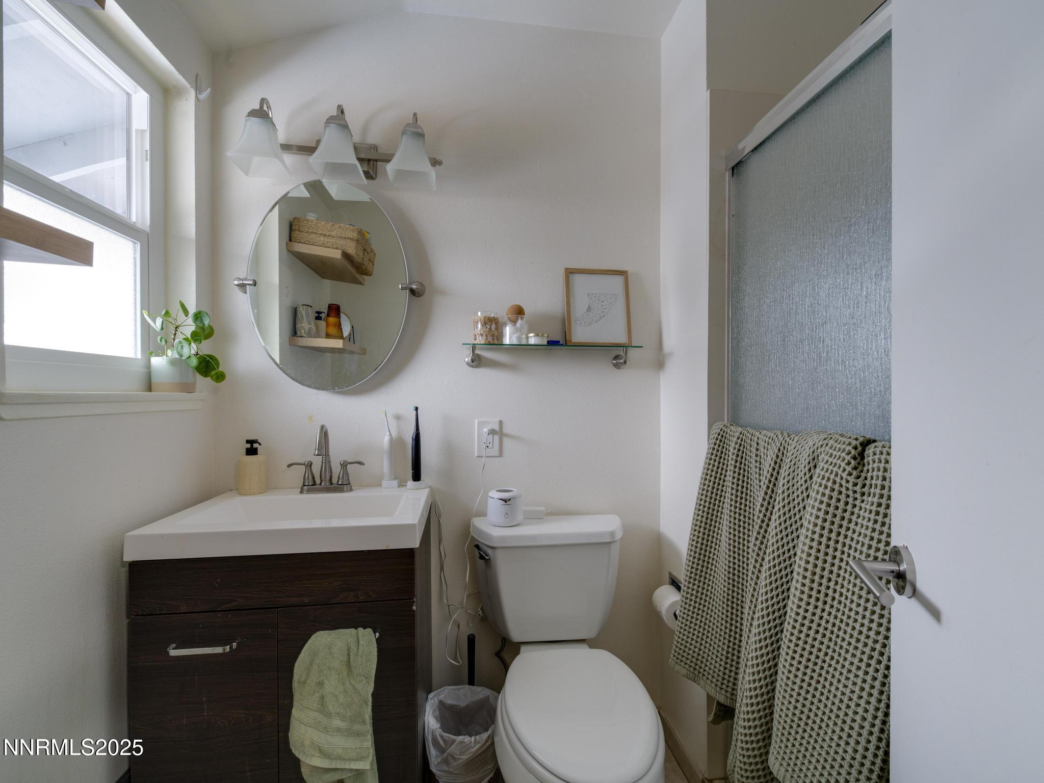 1840 Windsor Way Reno, NV 89503 - Photo 18 of 21 a bathroom with a toilet sink and mirror