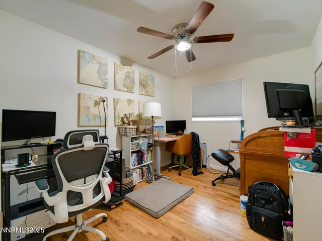 a view of a workspace with furniture and a flat screen tv