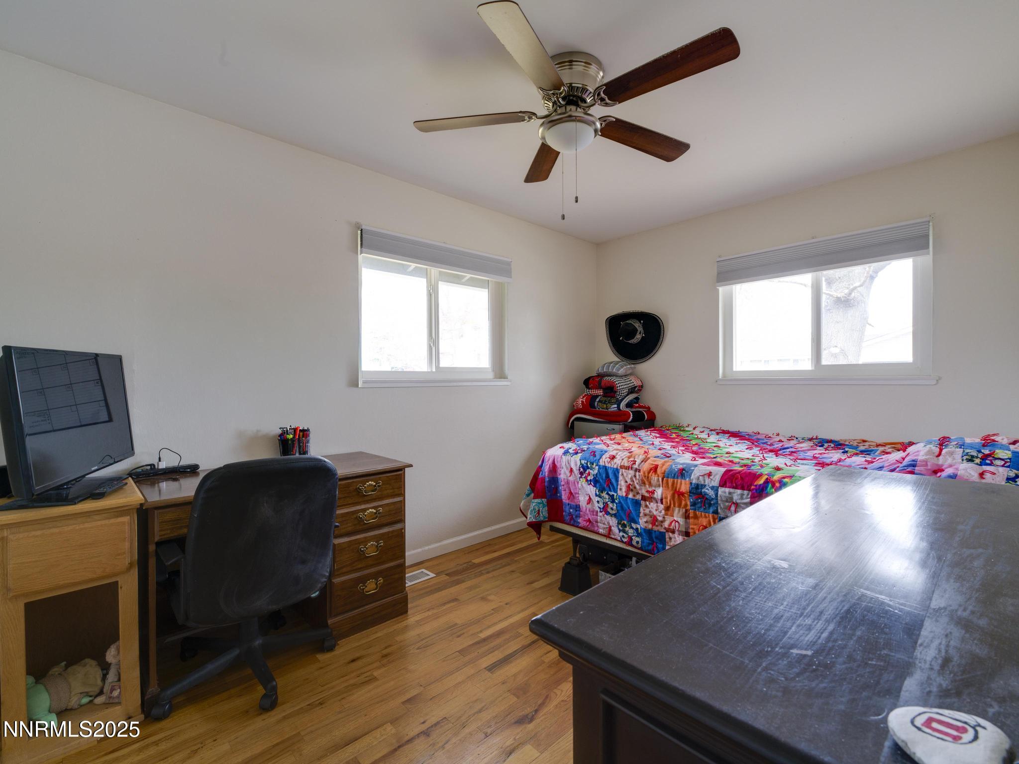 1840 Windsor Way Reno, NV 89503 - Photo 21 of 21 a bedroom with a bed and a chandelier