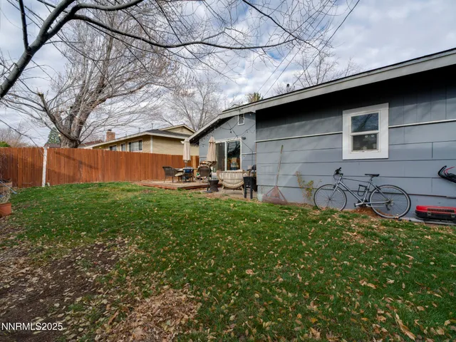 a backyard of a house with table and chairs