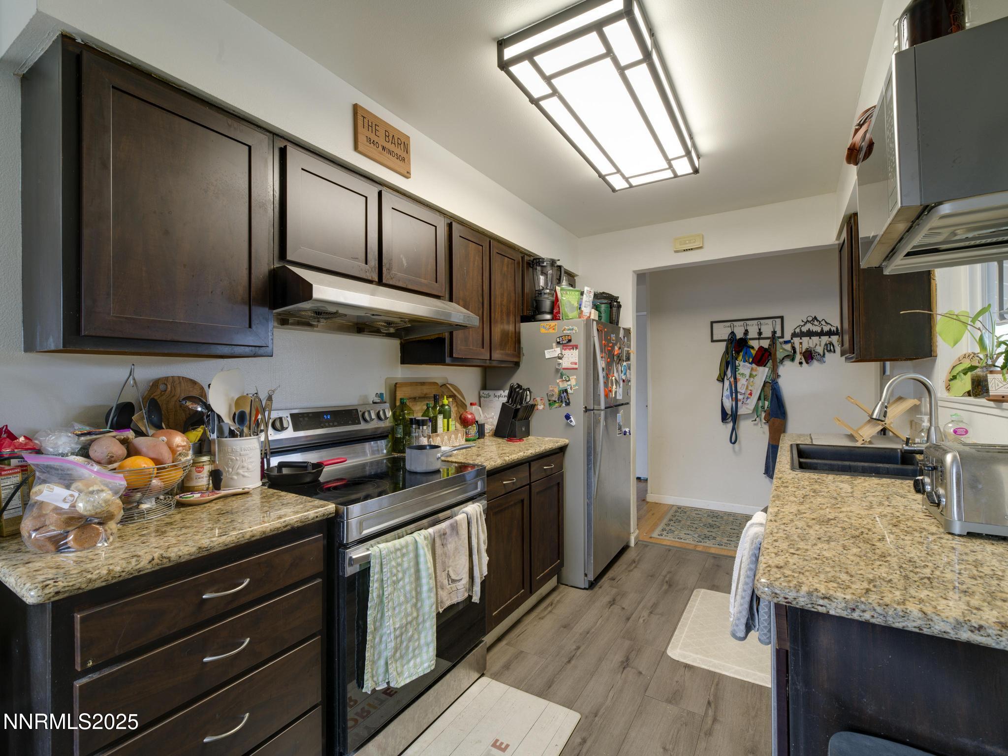 1840 Windsor Way Reno, NV 89503 - Photo 9 of 21 a kitchen with granite countertop lots of counter top space a sink and appliances