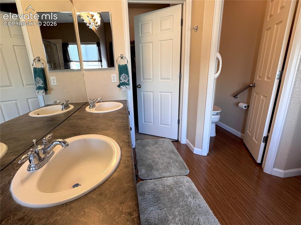 9362 St.George Road Peyton, CO 80831 - Photo 18 of 32 a bathroom with a sink and a mirror