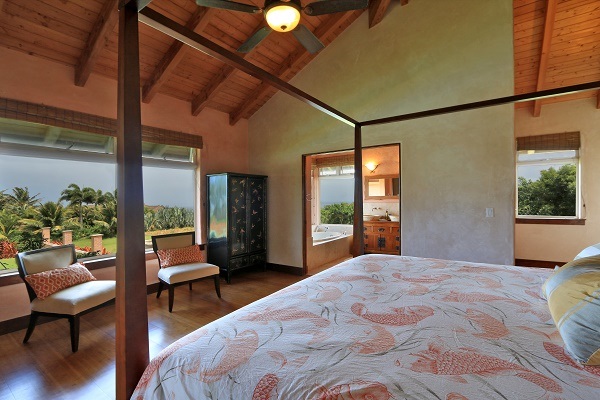 560 North Holokai Road Haiku, HI 96708 - Photo 13 of 30 a bedroom with a bed and wooden floor