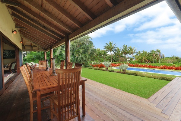 560 North Holokai Road Haiku, HI 96708 - Photo 14 of 30 a view of a patio with table and chairs potted plants with wooden floor and fence