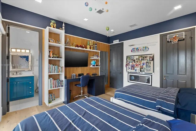 a bedroom with a bed and a flat screen tv