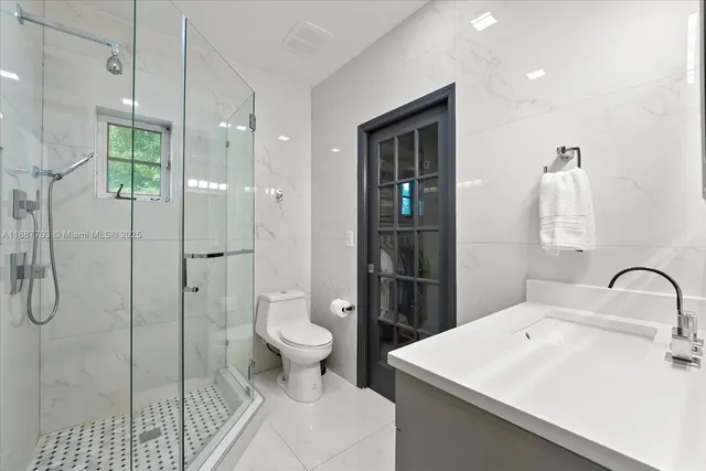 a bathroom with a sink toilet and shower