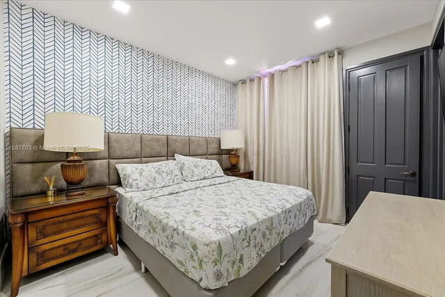 a bedroom with a bed and a dresser