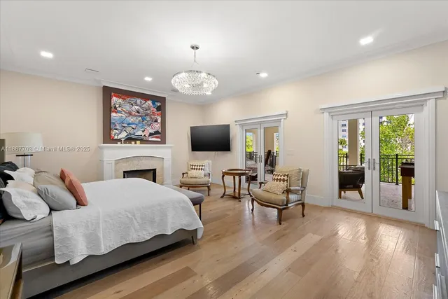 a spacious bedroom with a bed and a flat screen tv