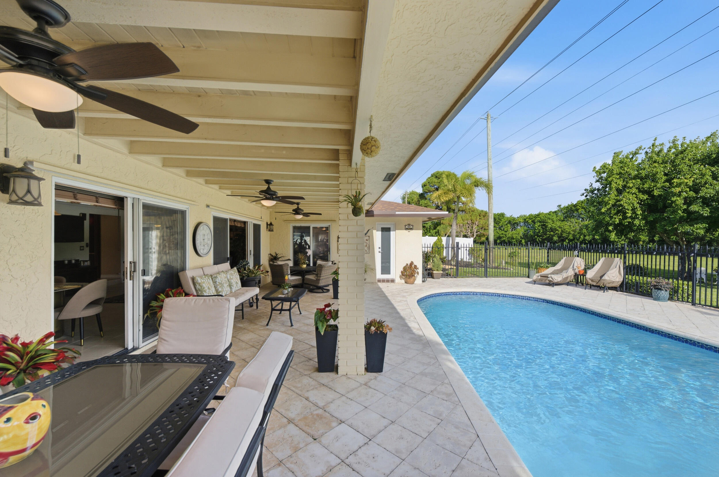 4780 Brandywine Drive Boca Raton, FL 33487 - Photo 27 of 43 a view of a patio with swimming pool table and chairs