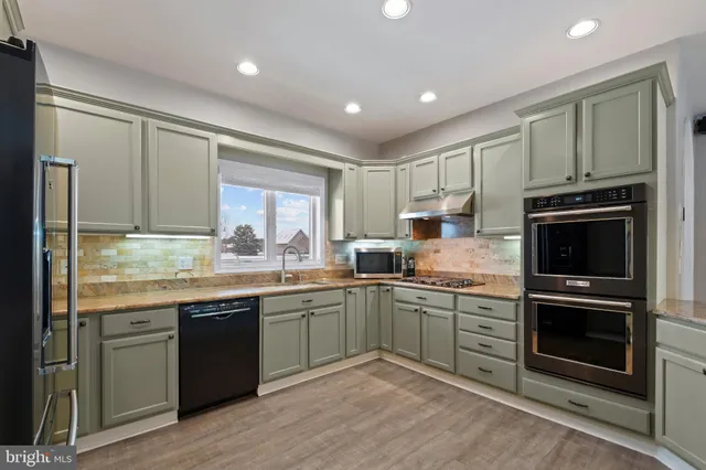 a kitchen with a sink stove and cabinets