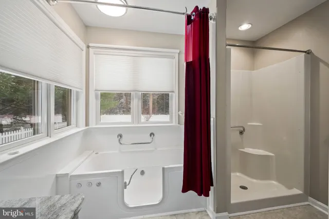 a bathroom with a bathtub and a shower
