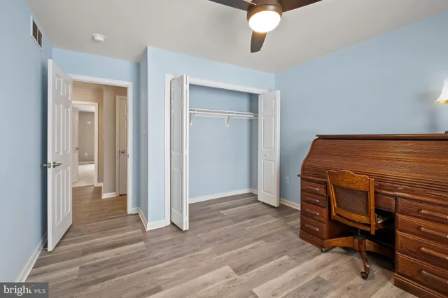 a view of an empty room and wooden floor