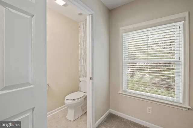 a view of a room with wooden floor and white walls