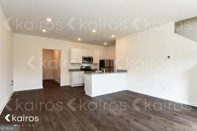 a kitchen with a refrigerator and a stove