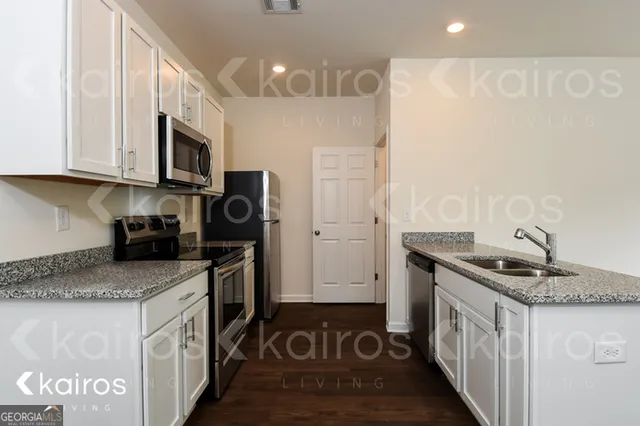 a kitchen with stainless steel appliances granite countertop a stove and a sink