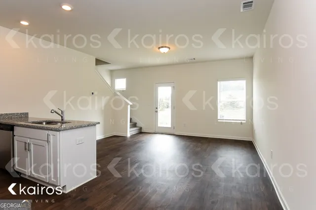 a kitchen with stainless steel appliances granite countertop a stove a sink and a large window