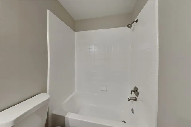 a bathroom with a bathtub and a toilet