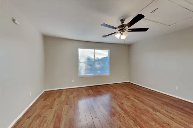 wooden floor in an empty room with a window