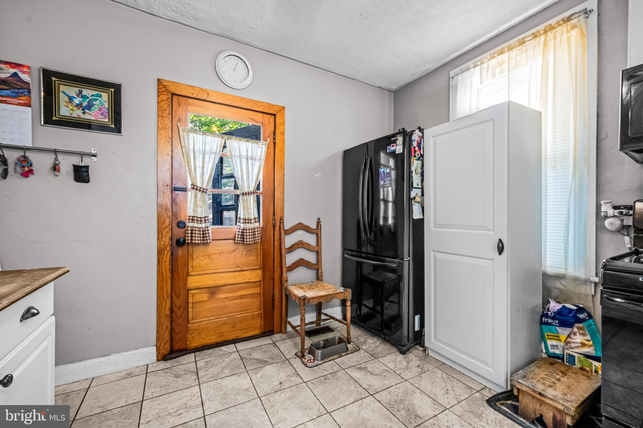 127 Cleveland Avenue Riverside, NJ 08075 - Photo 11 of 23 a view of a entryway with furniture and refrigerator