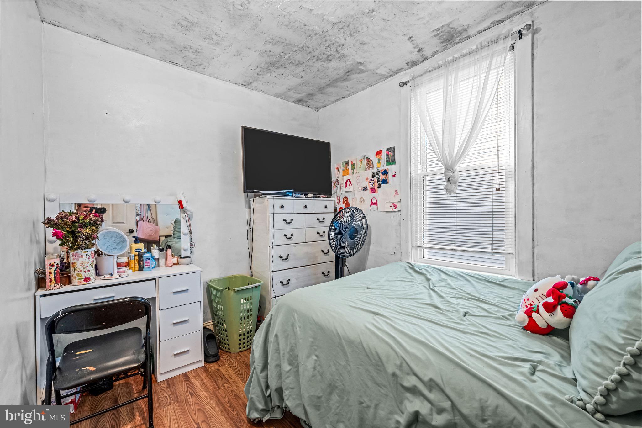 127 Cleveland Avenue Riverside, NJ 08075 - Photo 13 of 23 a bedroom with a bed a dresser and a flat screen tv