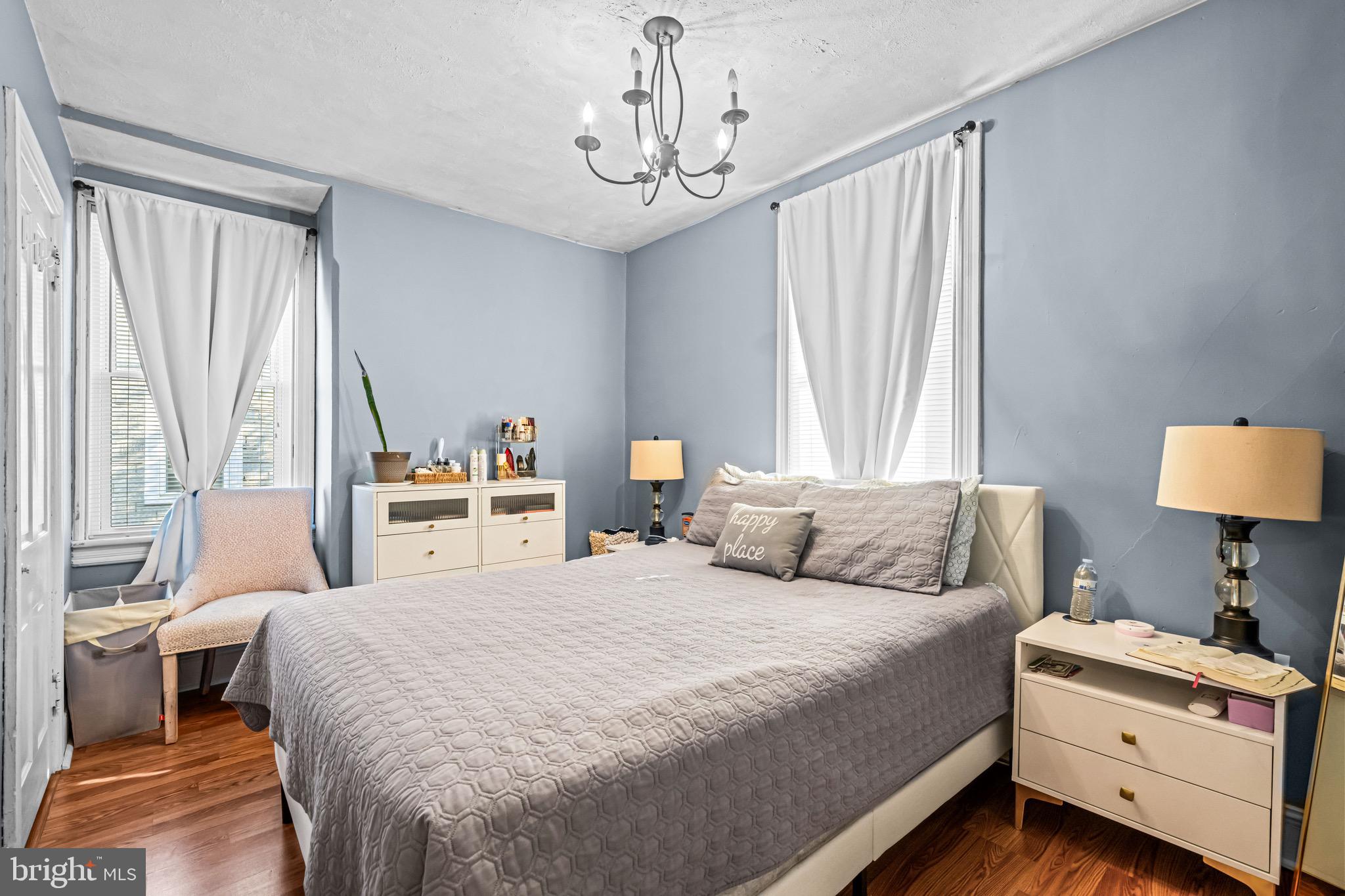 127 Cleveland Avenue Riverside, NJ 08075 - Photo 16 of 23 a bedroom with a bed and a chandelier