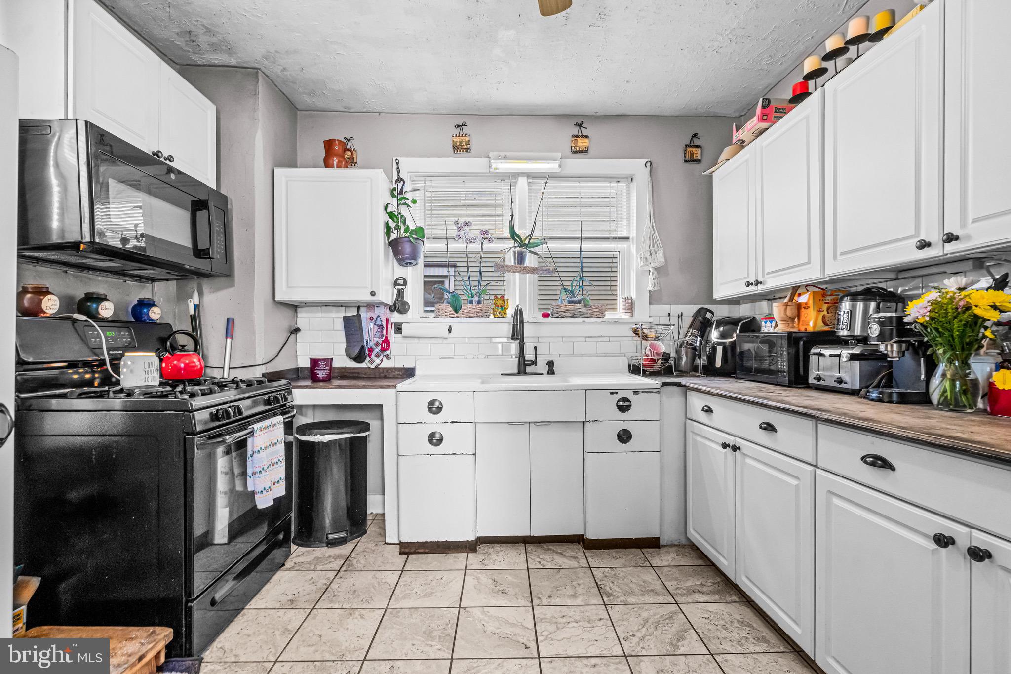 127 Cleveland Avenue Riverside, NJ 08075 - Photo 9 of 23 a kitchen with white cabinets and appliances