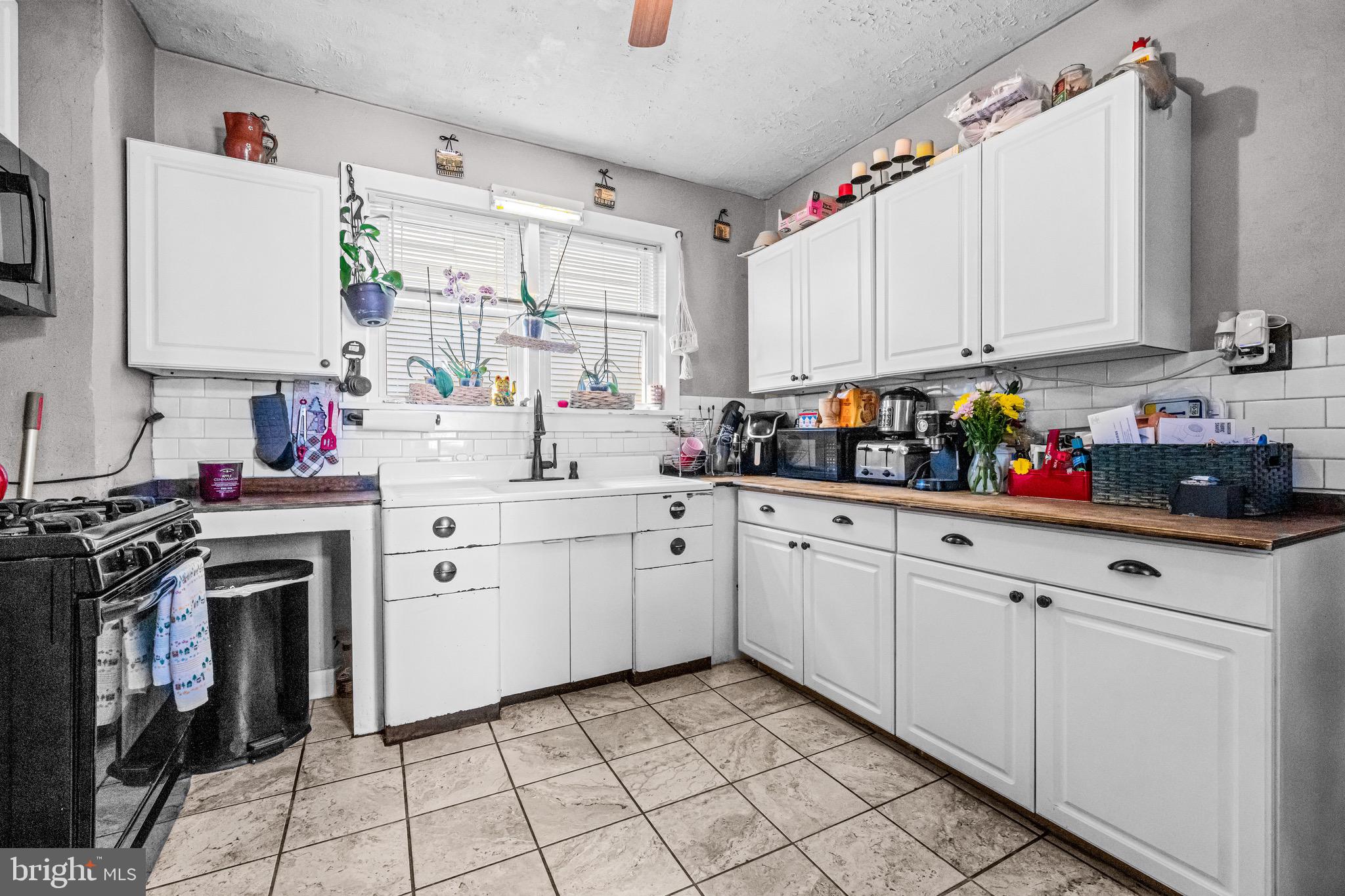 127 Cleveland Avenue Riverside, NJ 08075 - Photo 10 of 23 a kitchen with white cabinets and white appliances