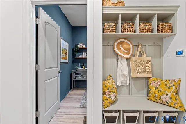 a view of a hallway with entryway wooden floor and front door