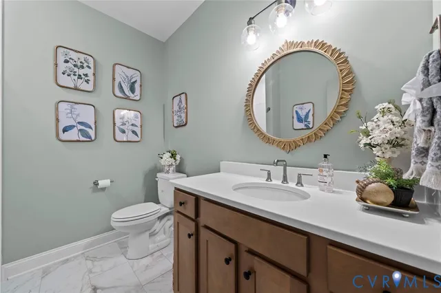 a bathroom with a sink mirror and toilet