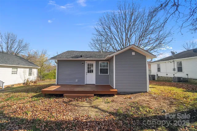 a backyard of a house with large trees