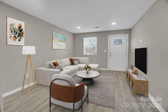 a living room with furniture and a flat screen tv
