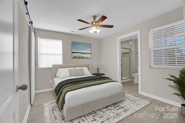 a bedroom with a large bed and a window